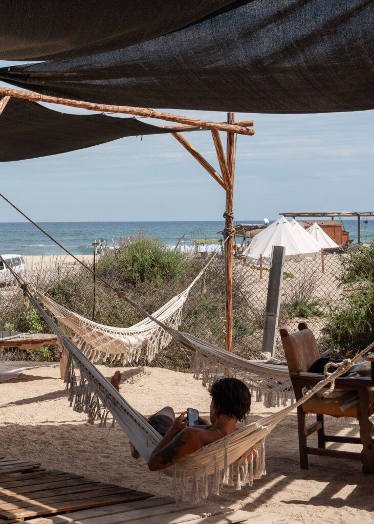 Guy in a hammock overlooking the ocean at Baja Station in La Fortuna, East Cape Baja Mexico