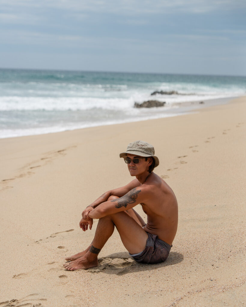 Guy sitting on the beach in East Cape in Baja California Sur Mexico